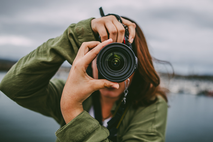 Woman taking picture with camera