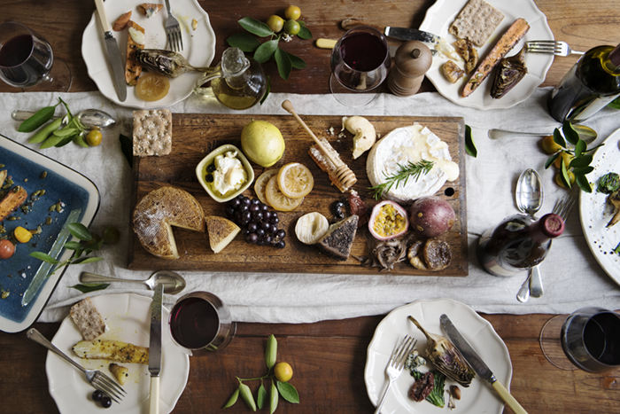Cheeseboard and plates on table